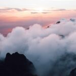 Misty clouds on a mountain range at sunset