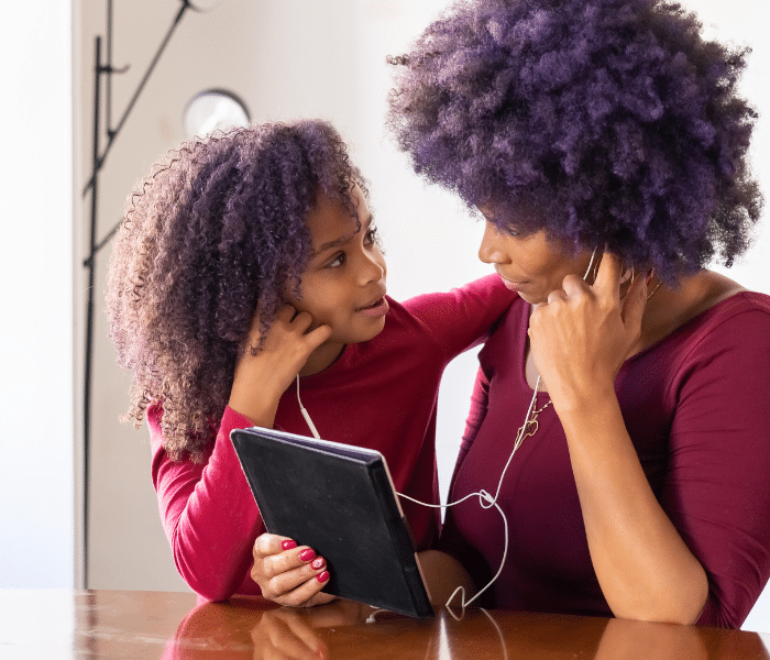 Mother and her child listening to music