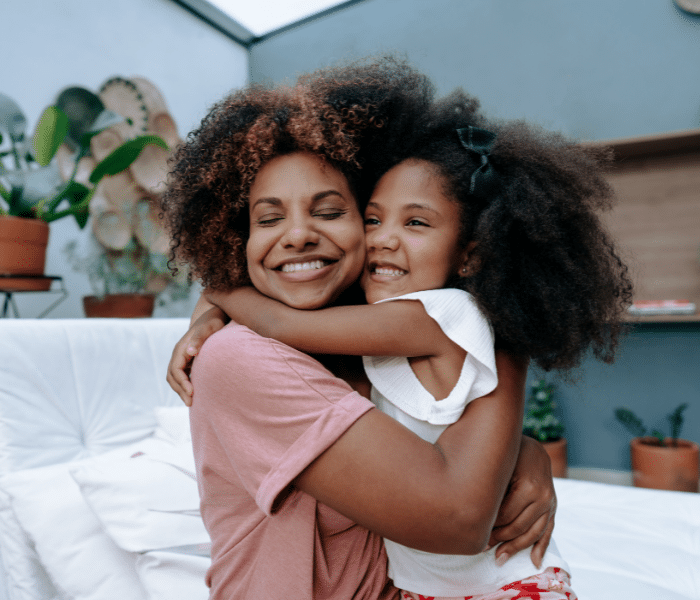 Mother hugging her daughter