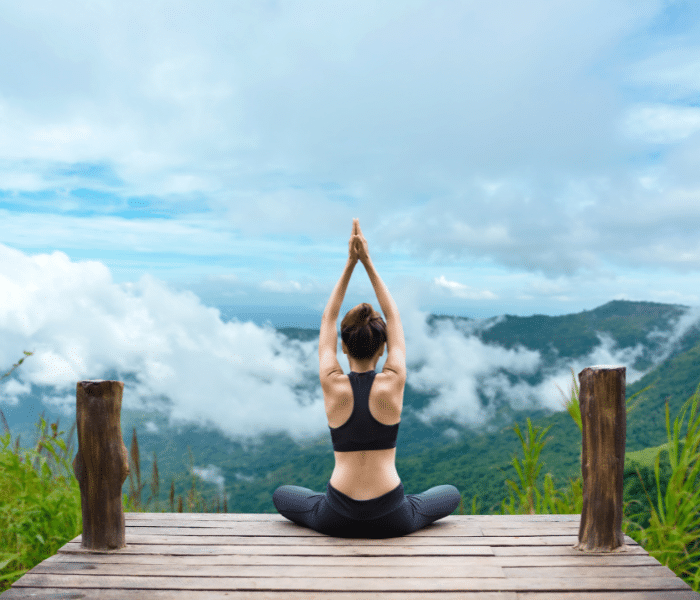 girl meditating in the mountains